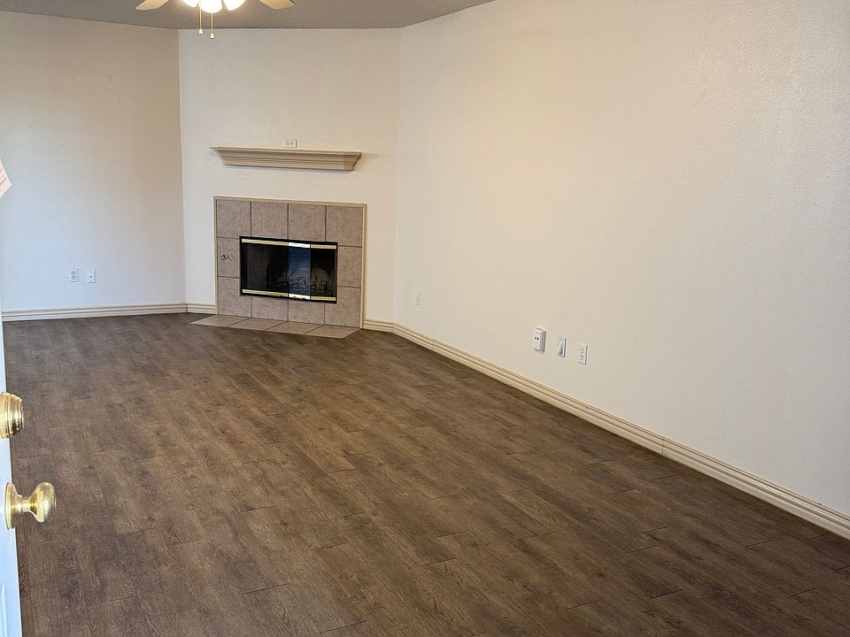 From entrance door to LR - showing fireplace and hall/kitchen.. on left of this photo