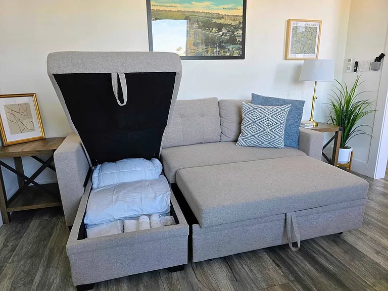 Living room (sofa bed, AC, TV, ceiling fan)
