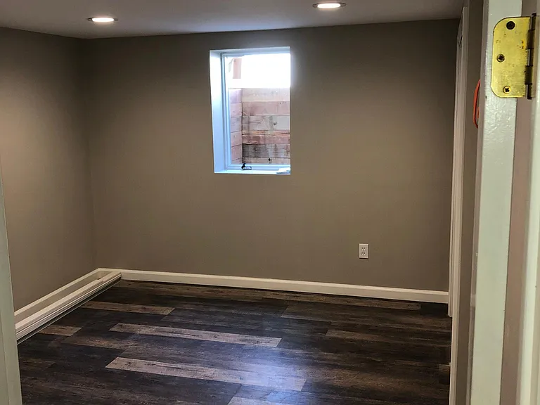 Basement bedroom with egress window bringing in plenty of natural light.