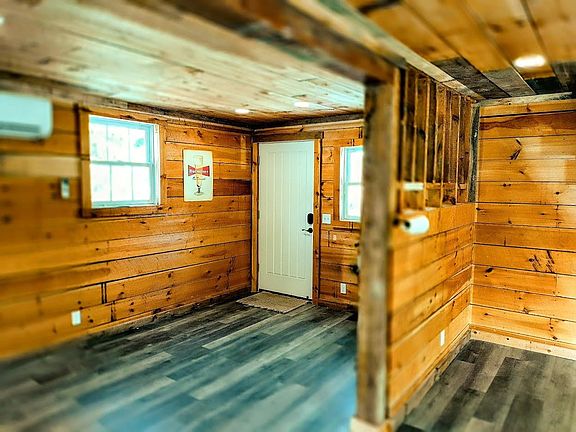 Entrance to the apartment with section of the original horse stall.