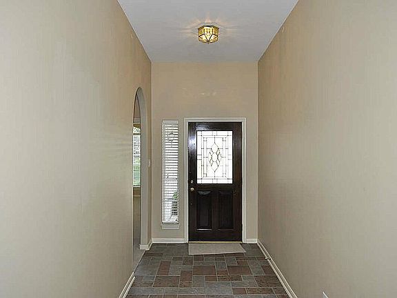 Foyer with tile floor & etched glass oak door!