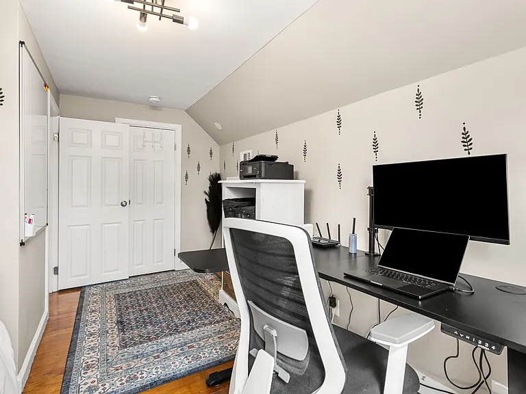 Sleep tight and work smart_your cozy queen bed and standing desk await! (Laptop is for photo purposes)