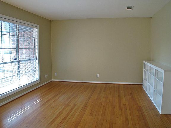 A large window floods the living room with natural light.  All windows have new 2 inch blinds.