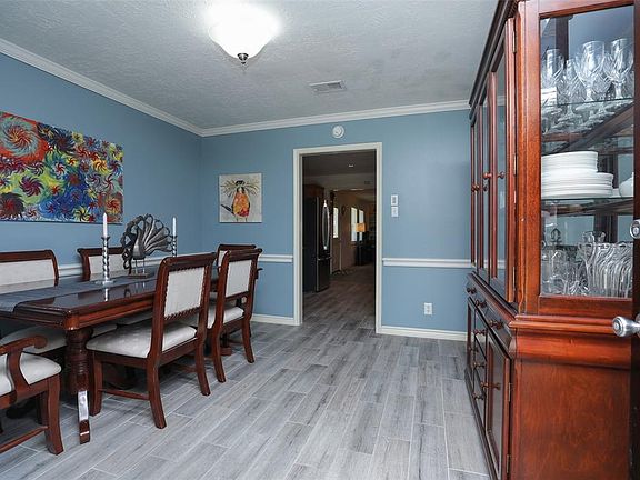 Entry into the formal dining. Notice the updated wood looking tile flooring throughout the entire home. No carpet, pet and kid friendly!