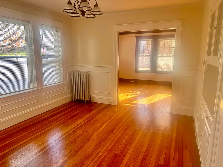Sunny dining room with built-in cabinet and storage shelves