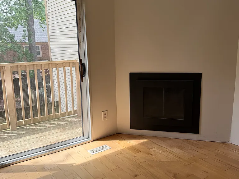 Main floor at the rear of the house - Hardwood floors, outdoor access, and a fireplace for everyday comfort.