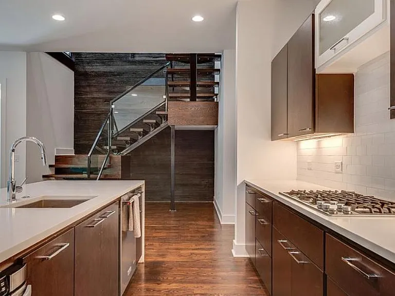 Kitchen with island, which will accommodate 5 bar stools and stairs leading to 2nd floor