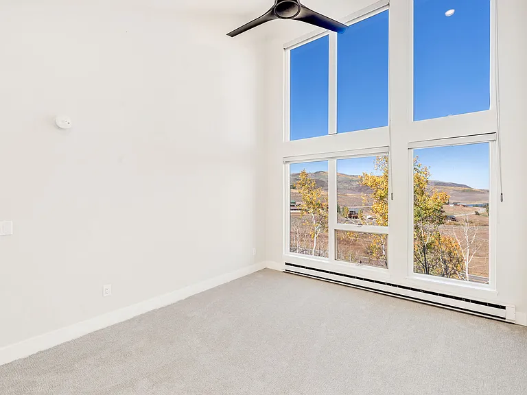 Bedroom #3 - on upper level. Floor to ceiling windows with electric black out window shades.