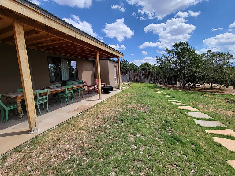 Covered flagstone portal with outdoor pine table seating 8.