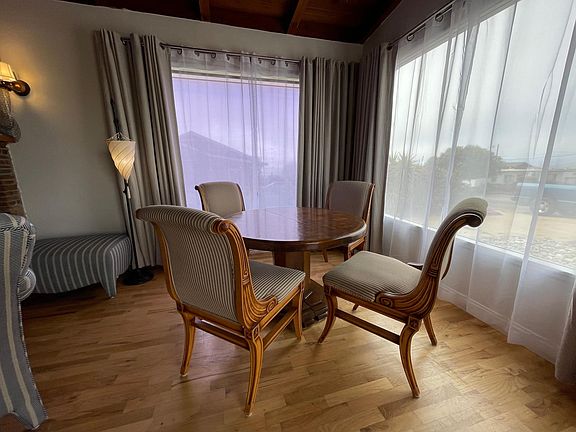 Intimate dining area with view of Morro Rock, the bay, jetty and ocean.