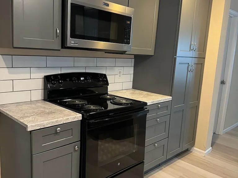 New Cabinets, countertop, backsplash. range, microwave, floor