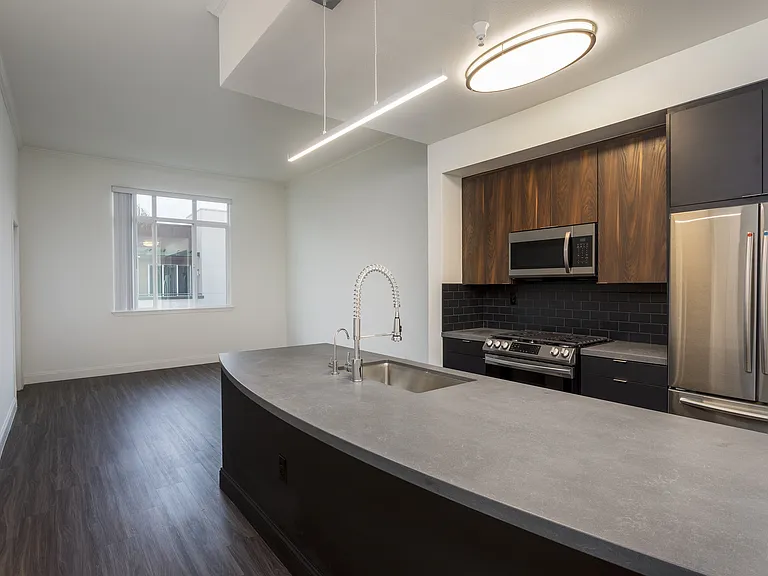 Kitchen with dark finishes at Reveal Playa Vista in Playa Vista, CA.