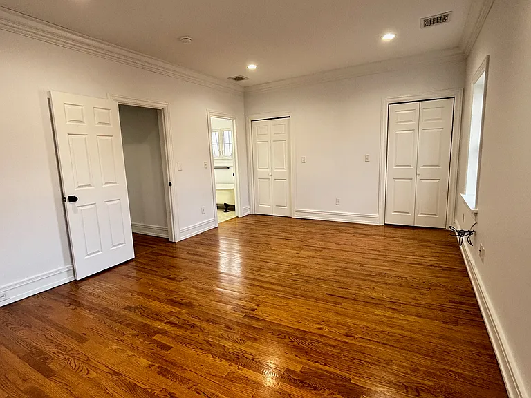 2nd Fl - EnSuite Primary Bedroom with Primary Bath and Hallway (l) and Double Lighted Closets (c)