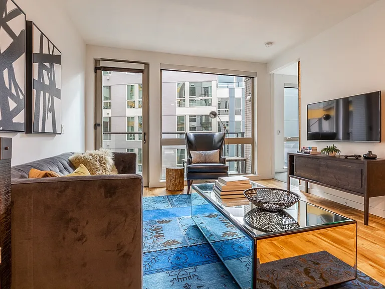 Open Living Space with Large Windows and Contemporary Furnishings
