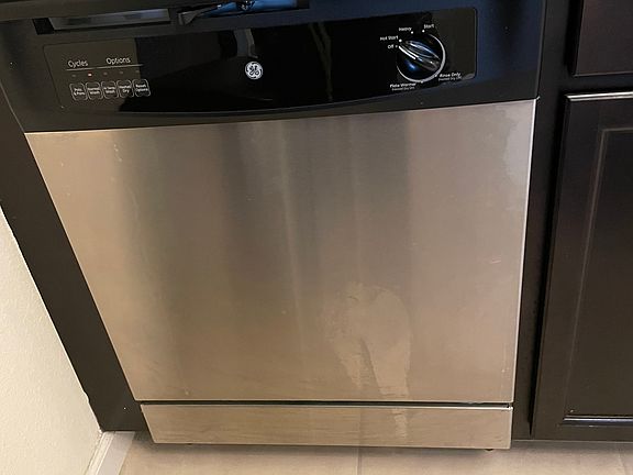 Kitchen with microwave, dishwasher & full fridge