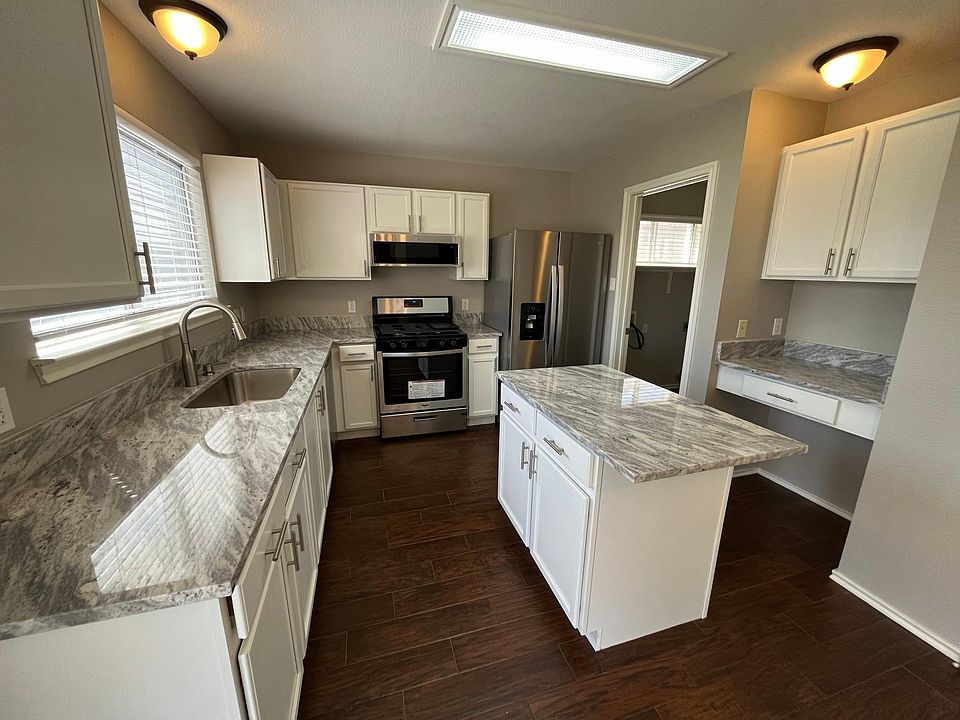 Kitchen has new granite counters, a brand new refrigerator, 5 burner gas range, dishwasher and microwave.