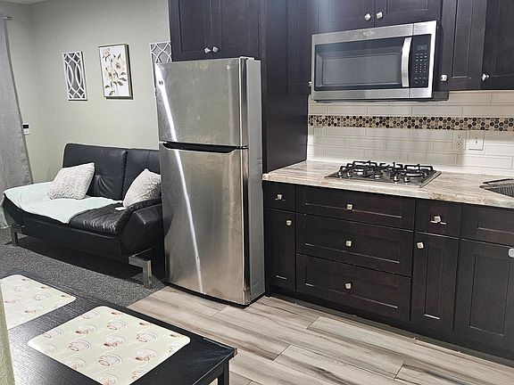 kitchenette front view, microwave, stove, and fridge included