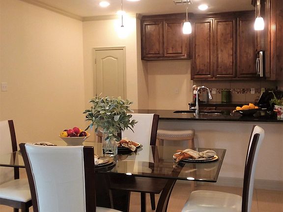 Dining and kitchen with long breakfast bar