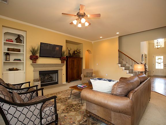 Beautiful Family room is enhanced by cast stone fireplace with gas logs flanked by two architectural niches; one featuring a built in display nook.