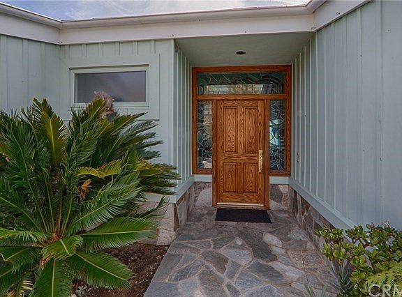 The entry features custom stained glass.