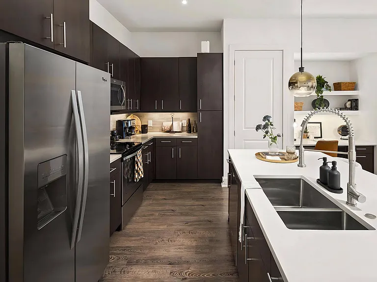 Stylish Kitchen with Stainless Steel Appliances and Dark Wood Cabinetry