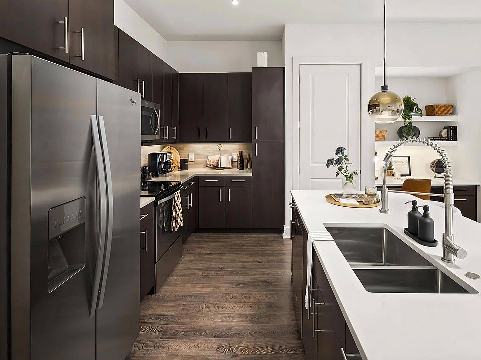 Stylish Kitchen with Stainless Steel Appliances and Dark Wood Cabinetry