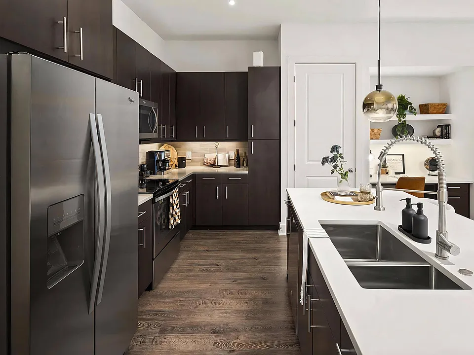 Stylish Kitchen with Stainless Steel Appliances and Dark Wood Cabinetry