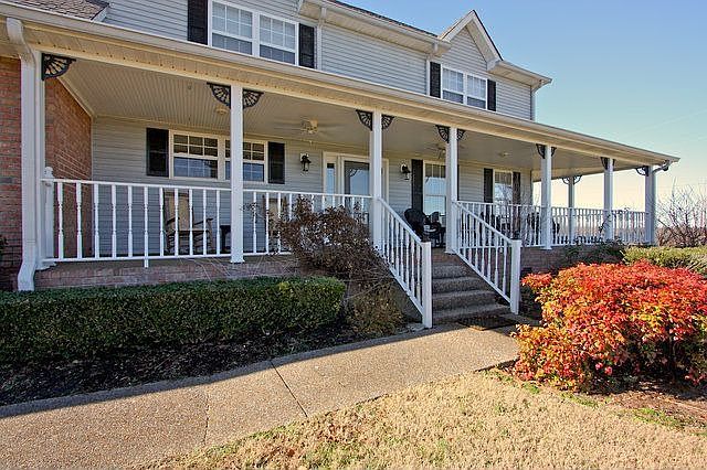 Wonderful wraparound front porch on this partial brick cape cod. 