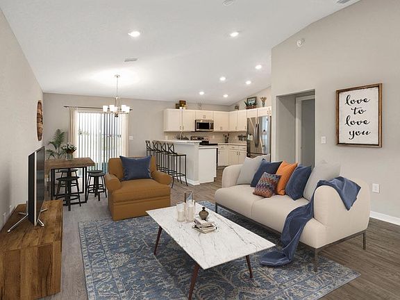 Enjoy a sunny, open living area with volume ceilings - Camellia home plan by Highland Homes