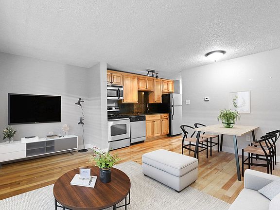 A modern living room with a wooden floor and white walls
