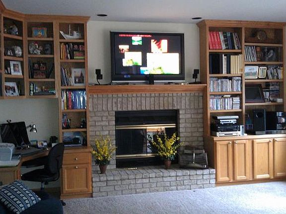 The family room with many built-ins and a gas fireplace, is near the kitchen.