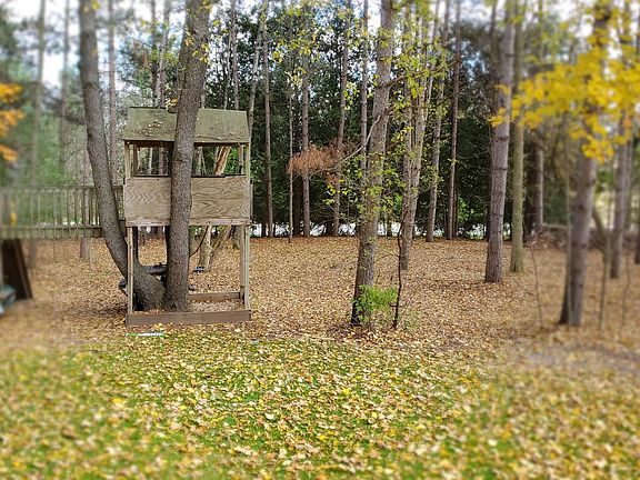 A fun custom-built treehouse and sandbox ready for play! The wooded park-like lot surrounds the home and runs all the way to the road.