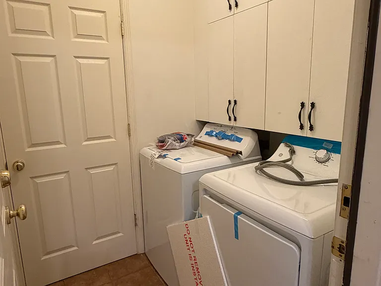 Laundry room with new washer and dryer