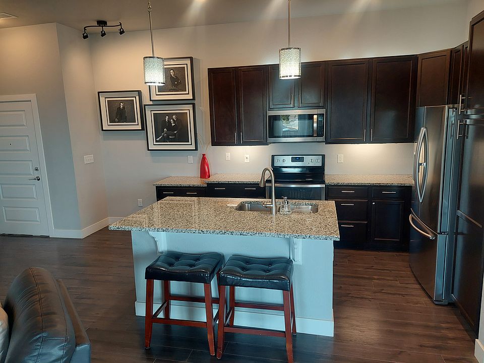 Kitchen from living room. Front door on left