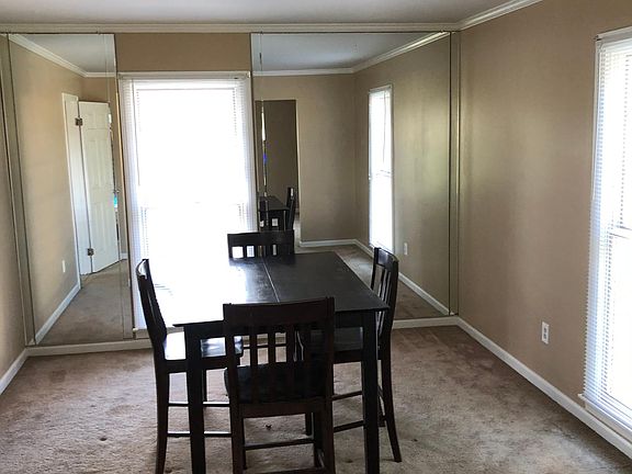 Large dining with big wall mirror, 2 large windows. Adjoins large Living room with 4 windows.