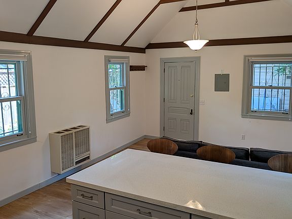 High ceiling living room & kitchen with tall seats for dining and entertaining