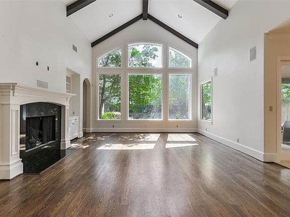 Great room features Cathedral ceilings and wood beams, while huge windows allow natural light to shine in.