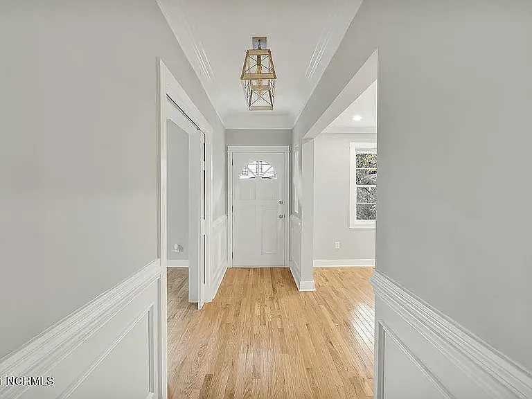 *original listing photo from when we purchased the home (downstairs hallway, looking at front door)