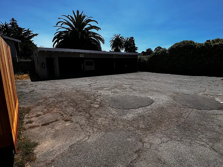 carport in background (1 assigned space per unit)