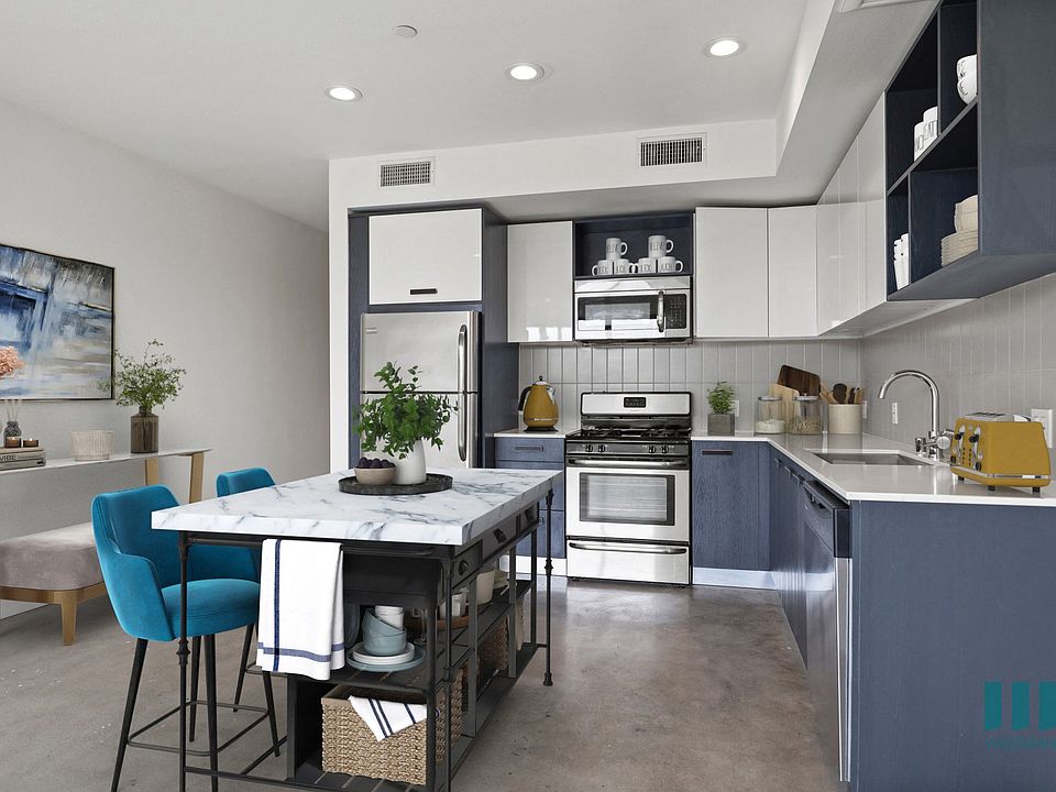 Open-Concept Kitchen and Dining Space with Concrete Flooring