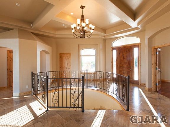 Iron railing around spiral staircase to the downstairs