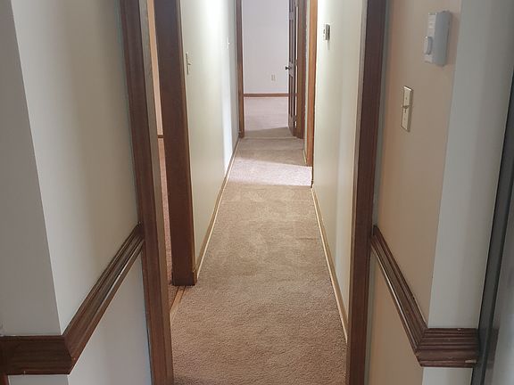 Hallway. Left: Den, Right 1: Bedroom, Right 2: Full Bath, Straight: Master Bedroom