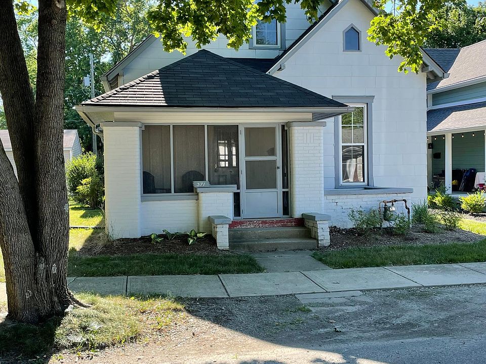 Front bungalow style home with screened in porch.