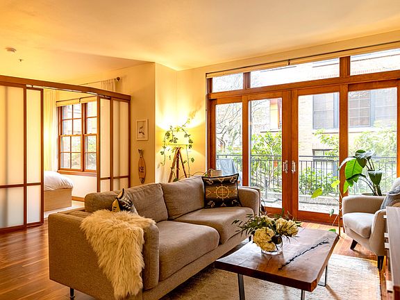Living area with Japanese screened in bedroom on the left and french doors opening onto a private 100sf patio in a secure interior courtyard