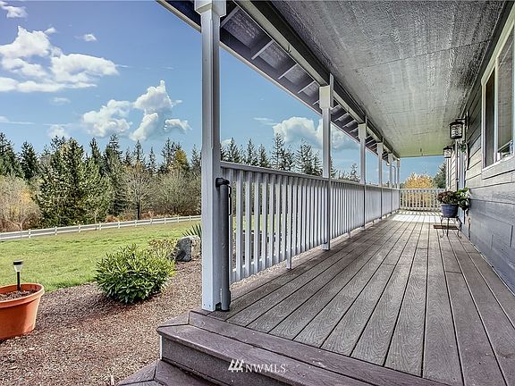 View of lovely front covered porch, length of the home :). 