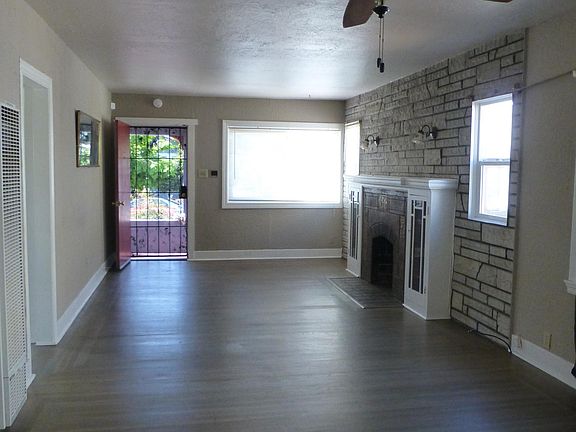 Living room and dining room combination with refinished hardwood floors.