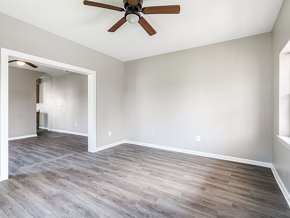 Living Room with door to the front of the house. Dinning room or additional living room. Entry way into the kitchen.
