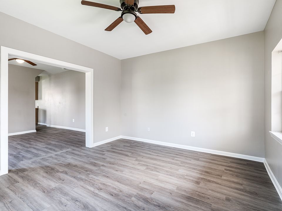 Living Room with door to the front of the house. Dinning room or additional living room. Entry way into the kitchen.