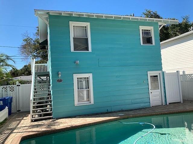 Pool Side View with Stairs to Apartment