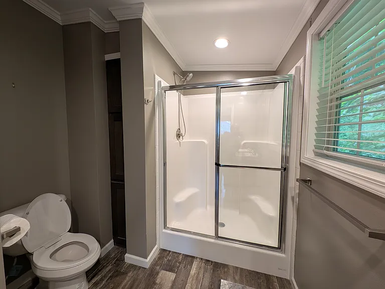 Storage cabinets to left of shower